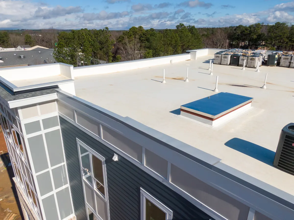 Commercial building with a white flat membrane roof and skylight