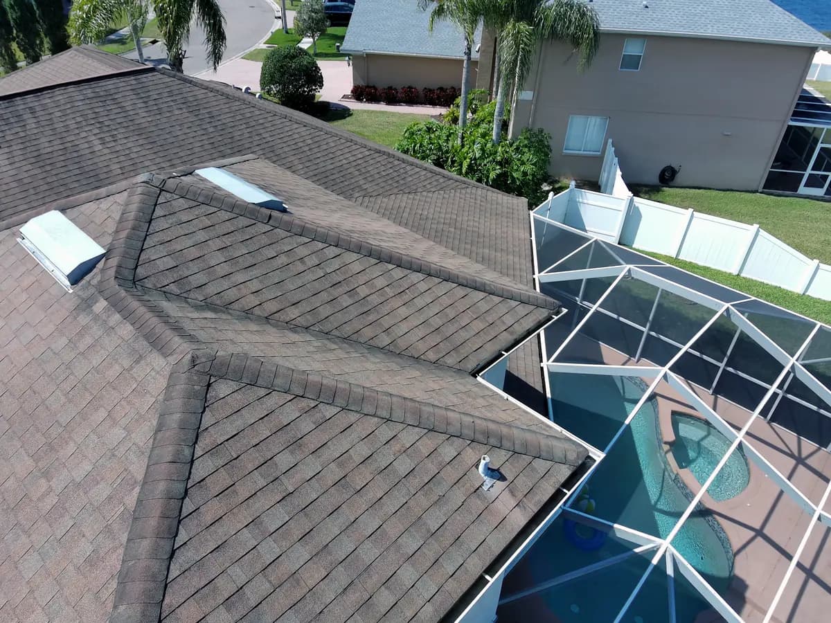 Florida home with a shingle roof and screened pool enclosure
